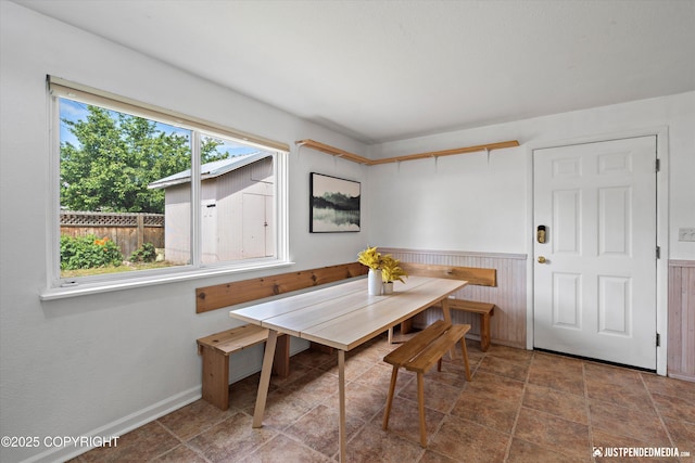 1602 Richardson Dr, Anchorage, AK 99504 - dining space with a wainscoted wall, breakfast area, stone finish flooring, and wooden walls