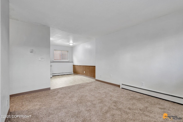 525 E 14th Ave, Anchorage, AK 99501 - spare room featuring carpet floors, wainscoting, and a baseboard heating unit