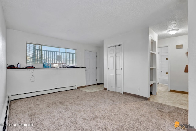 525 E 14th Ave, Anchorage, AK 99501 - unfurnished living room with a textured ceiling, baseboard heating, and carpet floors