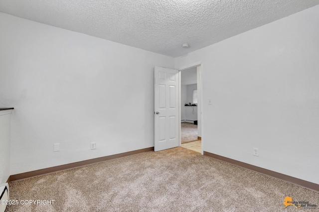 525 E 14th Ave, Anchorage, AK 99501 - carpeted empty room with a textured ceiling and a baseboard heating unit