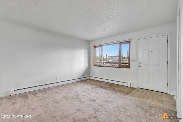 525 E 14th Ave, Anchorage, AK 99501 - foyer entrance with a textured ceiling, carpet flooring, and a baseboard heating unit