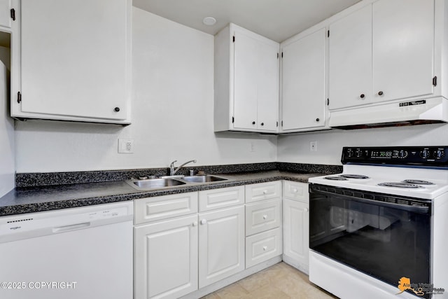 525 E 14th Ave, Anchorage, AK 99501 - kitchen with white appliances, under cabinet range hood, white cabinets, and dark countertops