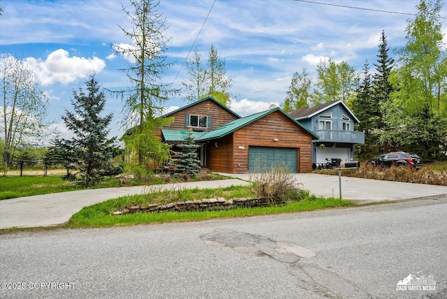 6537 Air Guard Rd, Anchorage, AK 99502 - chalet / cabin with concrete driveway and an attached garage