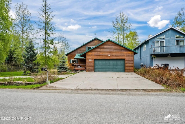 6537 Air Guard Rd, Anchorage, AK 99502 - rustic home with a garage and concrete driveway