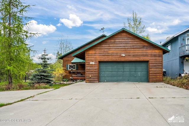 6537 Air Guard Rd, Anchorage, AK 99502 - rustic home featuring a garage and concrete driveway