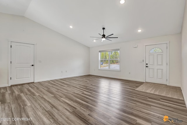 unfurnished living room featuring ceiling fan, lofted ceiling, wood finished floors, recessed lighting, and baseboards