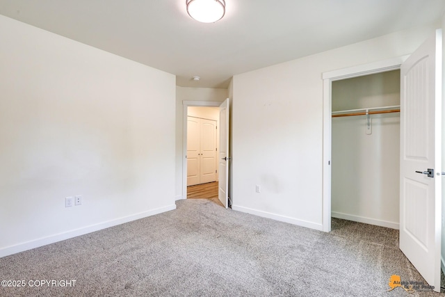 unfurnished bedroom with carpet, baseboards, and a closet