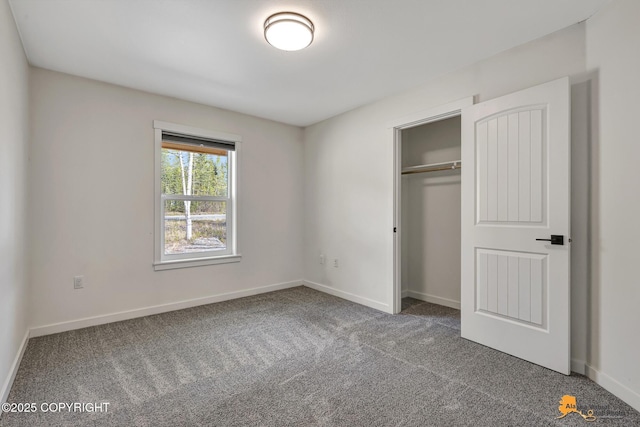 unfurnished bedroom with carpet, baseboards, and a closet