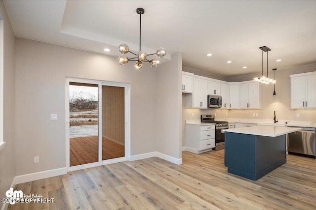 kitchen featuring appliances with stainless steel finishes, an inviting chandelier, recessed lighting, and a sink