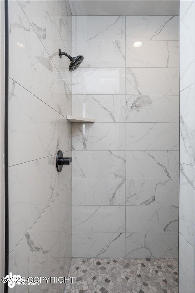 bathroom with a tile shower