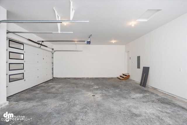 garage with a garage door opener and electric panel