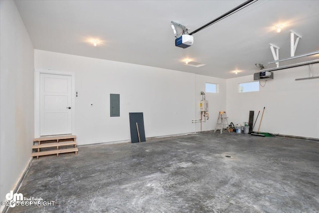 garage with a garage door opener and electric panel