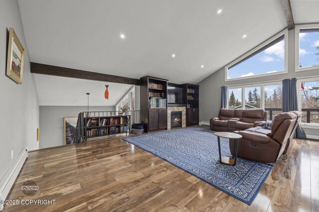 living area featuring high vaulted ceiling, plenty of natural light, baseboard heating, and beam ceiling