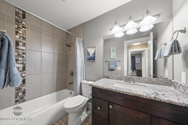 bathroom featuring toilet, shower / bathtub combination with curtain, wood finished floors, and vanity
