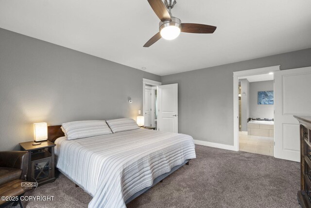 carpeted bedroom featuring baseboards, ensuite bathroom, and ceiling fan