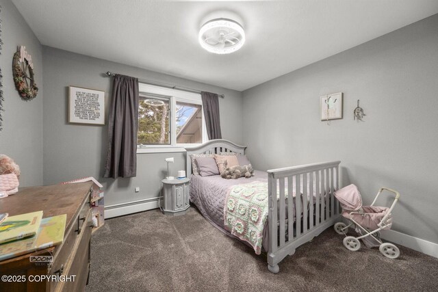 bedroom with carpet floors, baseboards, and a baseboard heating unit