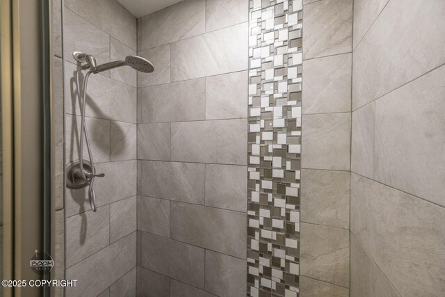 interior details featuring a tile shower