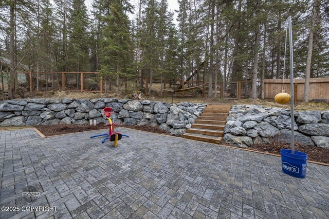 view of patio / terrace featuring stairs and a fenced backyard