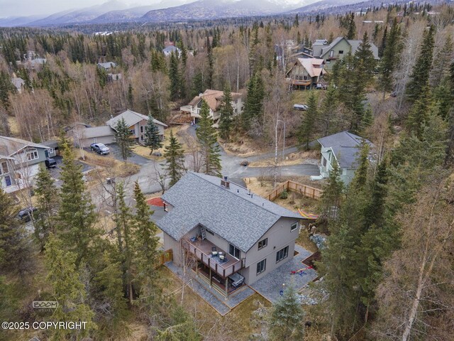 aerial view featuring a mountain view and a forest view