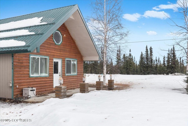 910 Refinery Loop, North Pole, AK 99705 - view of snow covered exterior featuring metal roof and faux log siding