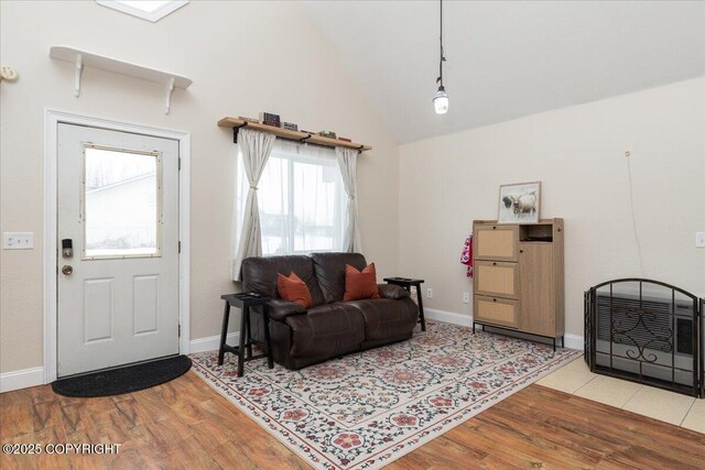 910 Refinery Loop, North Pole, AK 99705 - living room with high vaulted ceiling, light wood-style flooring, and baseboards