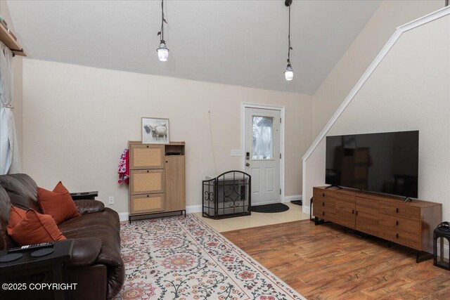 910 Refinery Loop, North Pole, AK 99705 - living area featuring baseboards, wood finished floors, and lofted ceiling