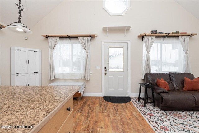 910 Refinery Loop, North Pole, AK 99705 - foyer featuring baseboards, high vaulted ceiling, and light wood-style floors