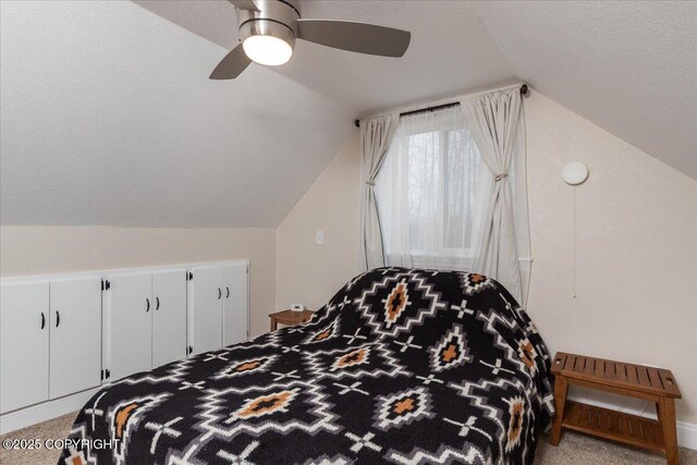 910 Refinery Loop, North Pole, AK 99705 - bedroom featuring carpet floors, a ceiling fan, vaulted ceiling, and a textured ceiling
