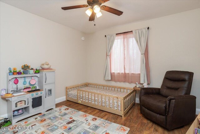 910 Refinery Loop, North Pole, AK 99705 - bedroom with baseboards, a ceiling fan, and wood finished floors