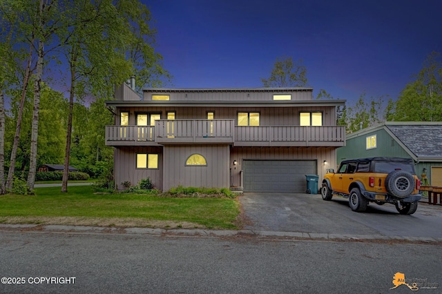 3210 Seawind Dr, Anchorage, AK 99516 - view of front of house with a balcony, asphalt driveway, an attached garage, and a front lawn