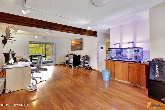 3210 Seawind Dr, Anchorage, AK 99516 - office area with a textured ceiling, wood finished floors, beam ceiling, track lighting, and baseboards
