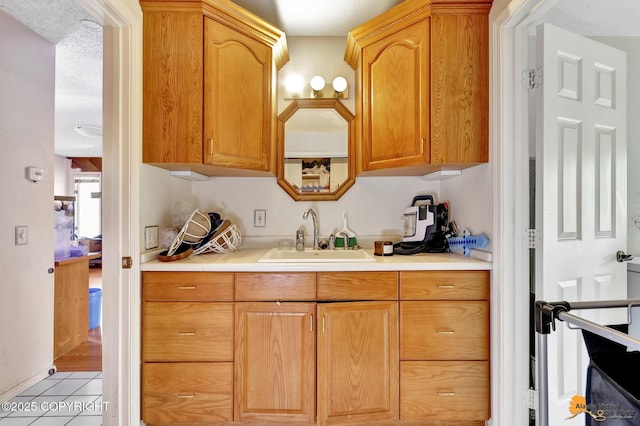 3210 Seawind Dr, Anchorage, AK 99516 - kitchen featuring a sink, light countertops, and light tile patterned flooring