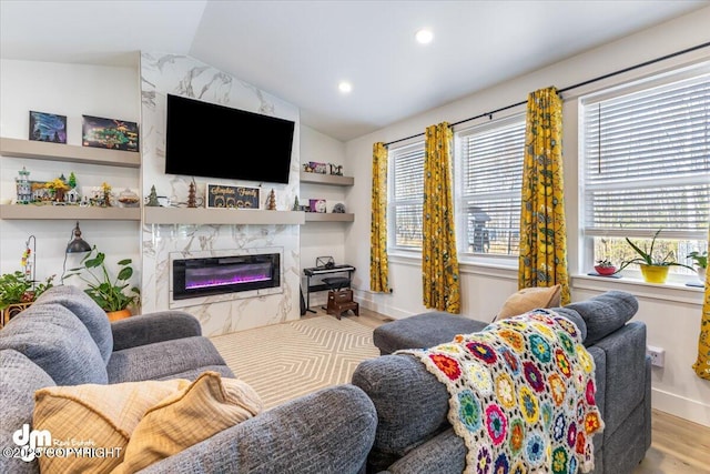 3460 S Shamrock St, Wasilla, AK 99623 - living room featuring wood finished floors, vaulted ceiling, a premium fireplace, recessed lighting, and baseboards