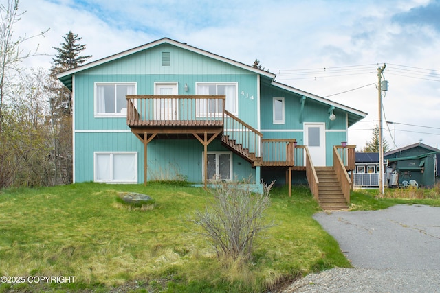 414 Bonanza Ave, Homer, AK 99603 - back of property featuring stairway, a deck, and a lawn