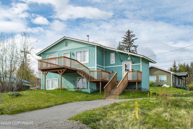 414 Bonanza Ave, Homer, AK 99603 - rear view of house featuring a deck, stairway, and a yard