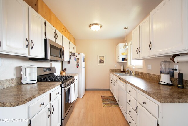 414 Bonanza Ave, Homer, AK 99603 - kitchen with appliances with stainless steel finishes, a sink, light wood-style flooring, and dark countertops