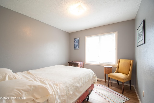 414 Bonanza Ave, Homer, AK 99603 - bedroom with wood finished floors, baseboards, and a textured ceiling