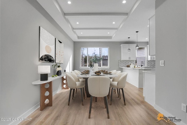 3169 N Gaviidae Dr, Wasilla, AK 99623 - dining area with recessed lighting, a tray ceiling, baseboards, and light wood-type flooring