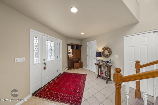 entryway with baseboard heating, baseboards, recessed lighting, light tile patterned floors, and stairs