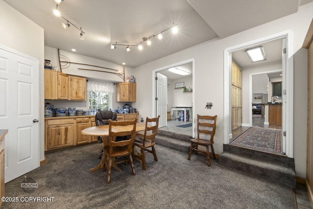 dining room featuring dark colored carpet
