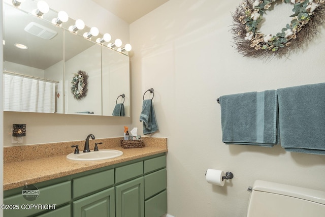 bathroom featuring toilet and vanity