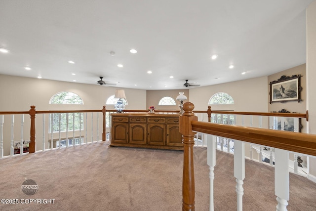 hall with light colored carpet, recessed lighting, and plenty of natural light