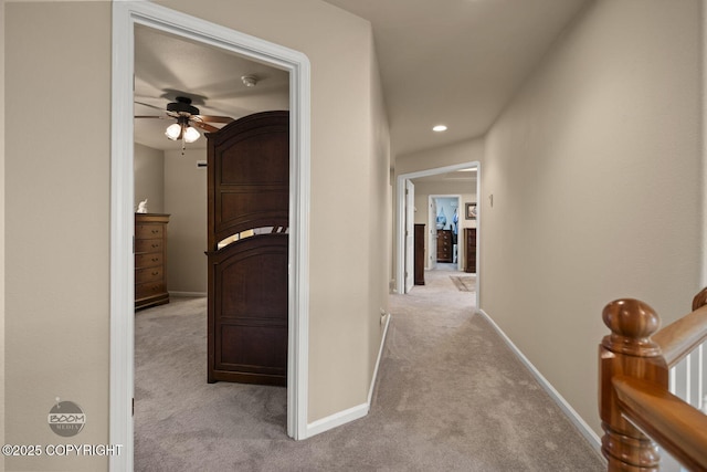 hall featuring carpet floors, baseboards, and recessed lighting