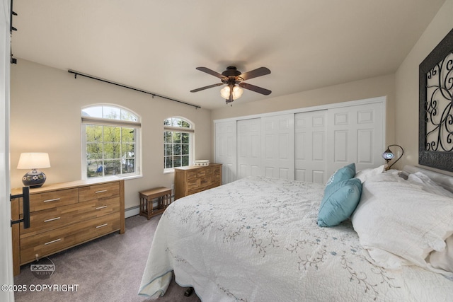 bedroom with dark carpet, a closet, and a ceiling fan