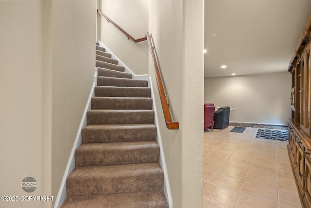stairway featuring tile patterned flooring, recessed lighting, and baseboards