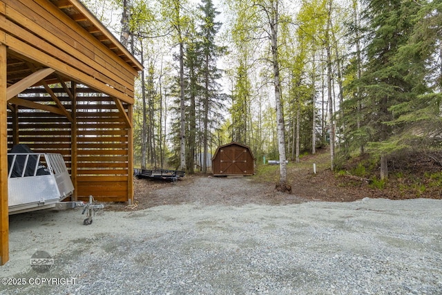 view of yard with a shed and an outbuilding