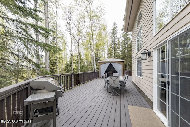 wooden terrace with outdoor dining area