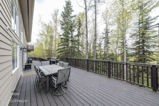 deck featuring outdoor dining area