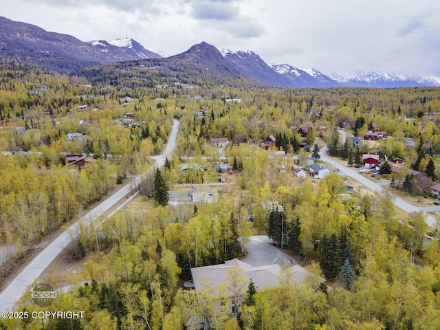 aerial overview of property's location featuring a heavily wooded area and mountains