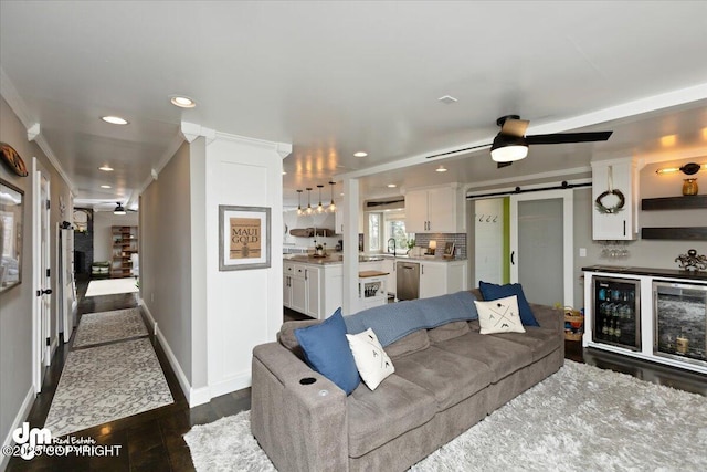 23231 Glacier View Dr, Eagle River, AK 99577 - living room featuring baseboards, a barn door, dark wood-type flooring, and recessed lighting